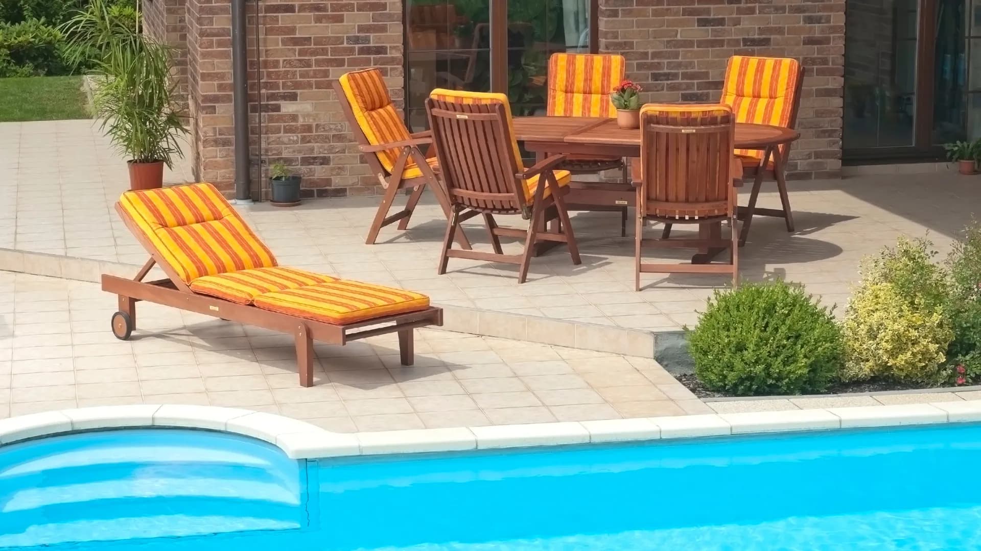 Poolside loungers on a stone pool deck