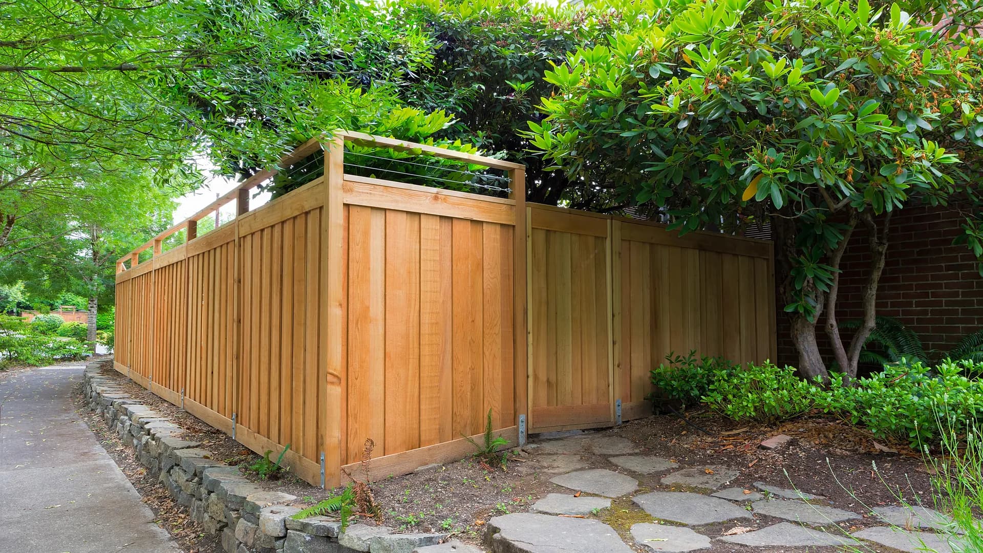 A wood fence with vines growing along it